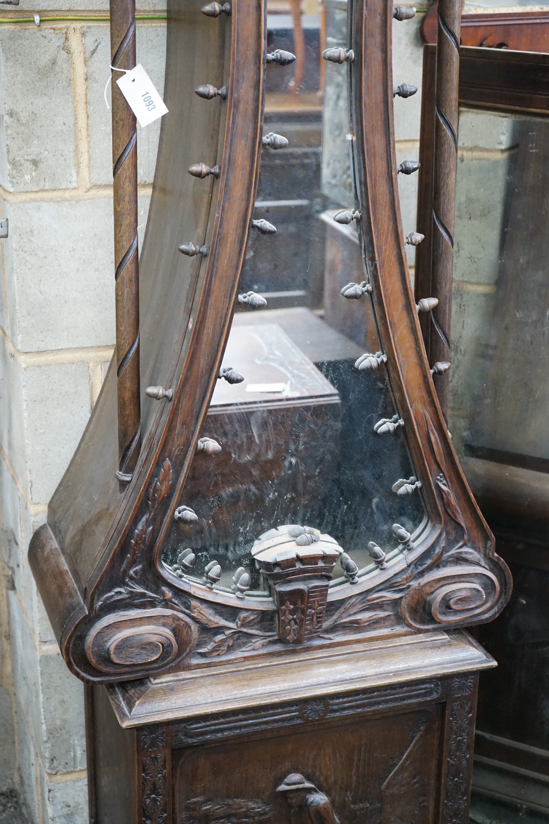An early 20th century Flemish carved oak and walnut longcase clock, height 240cms.